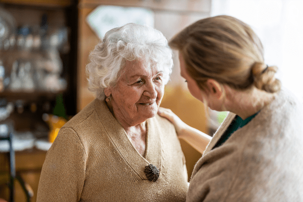 Resident speaking with a caretaker at The Birches at Newtown in Newtown, Pennsylvania