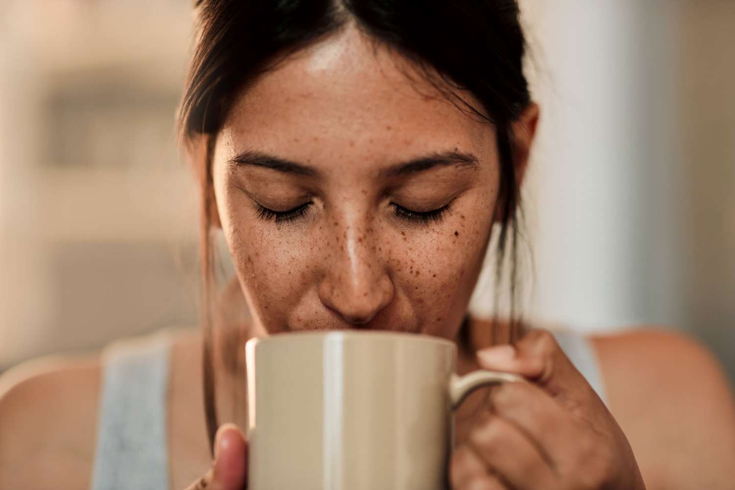 Resident drinking out of a mug at Columbine Apartments in Littleton, Colorado
