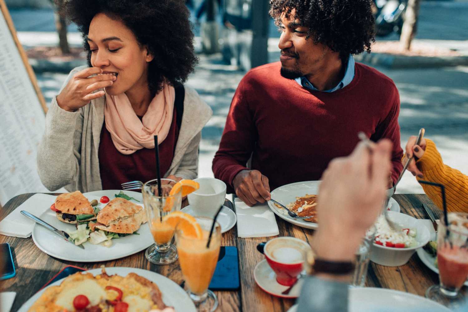 Residents having delicious food at a restaurant near Maple Heights Apartments in Saline, Michigan