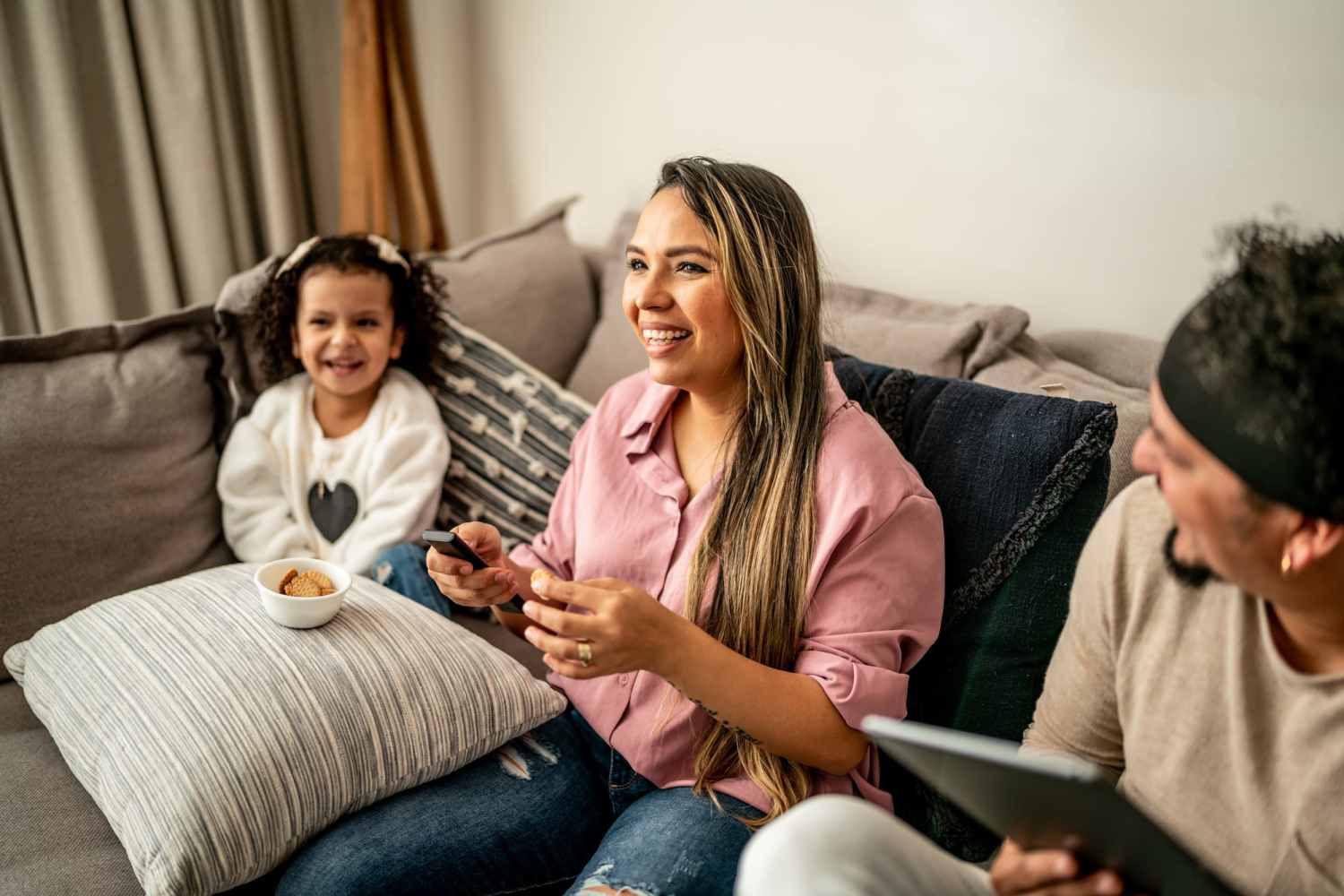 Little girl with the residents in living room at Mayville Apartments in Mayville, Michigan