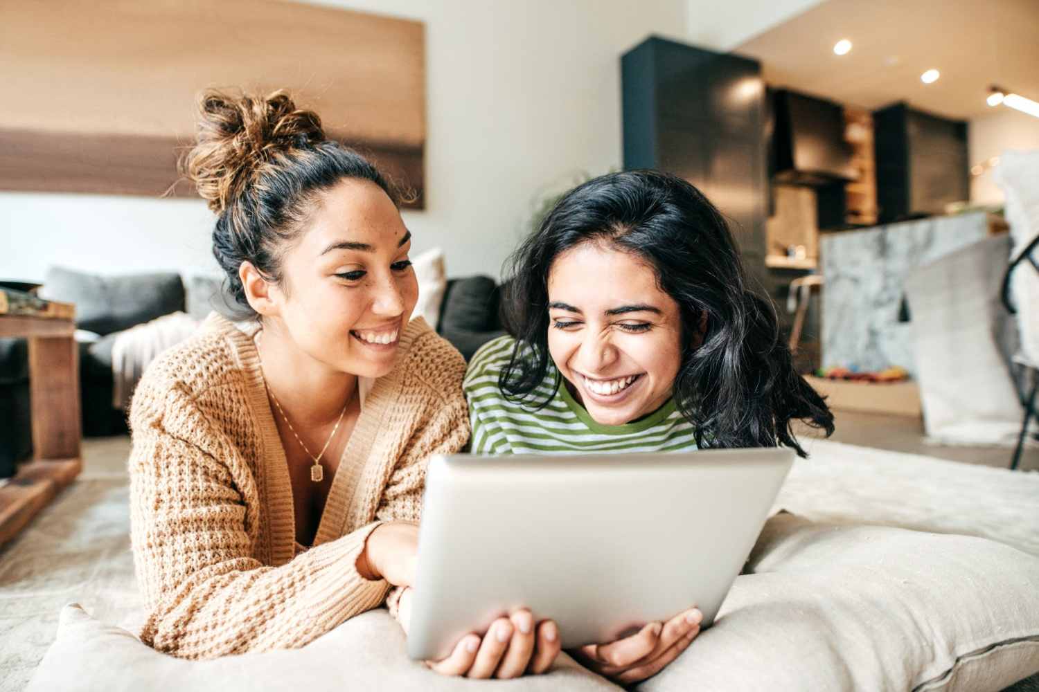 Happy friend on their laptop at Sable Pointe Apartments in Hart, Michigan