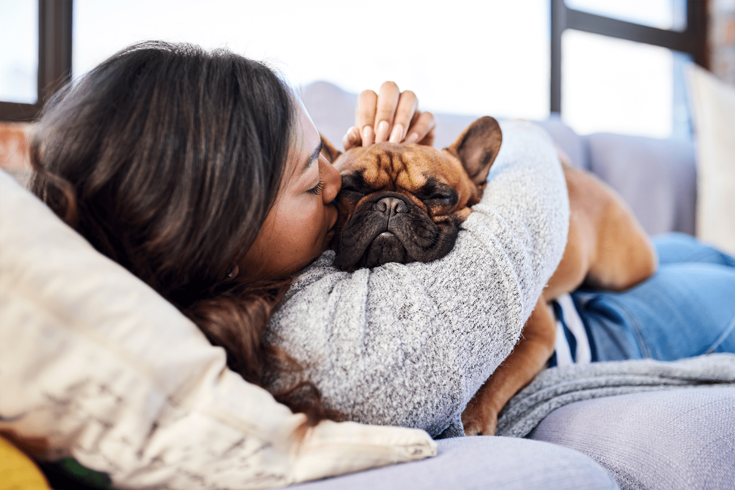 Resident snuggling with her French bulldog at Vantage Pointe West Apartment Homes in Cincinnati, Ohio