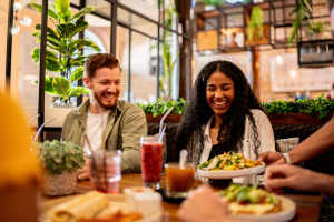 Friends having food at a restaurant near Martin Flats in Nashville, Tennessee