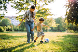 Resident woman playing with her son in a park at Seaglass Cottage in North Myrtle Beach, South Carolina