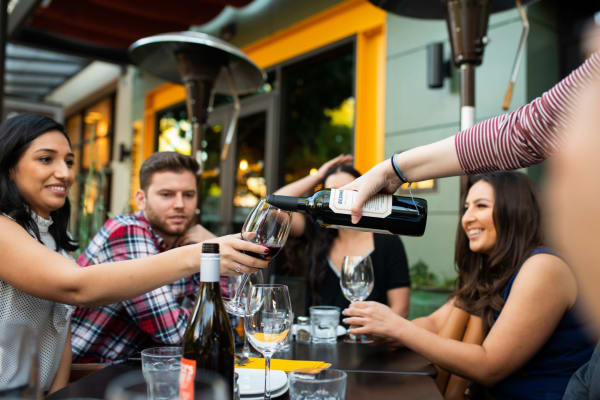 Resident raising a toast to the good life at Novella at Arcadia in Phoenix, Arizona