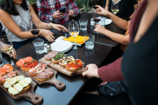 Residents enjoying charcuterie boards and wine at their favorite hot spot near Jade Apartments in Las Vegas, Nevada