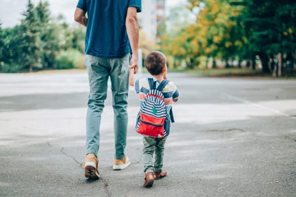 A resident walking a child to a school near BB Living at Union Park in Phoenix, Arizona