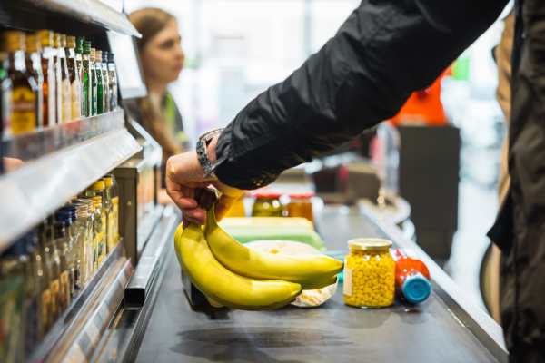 Resident handing over her credit card to a cashier at a downtown boutique near Victoria Pointe Apartments in Jackson, Michigan