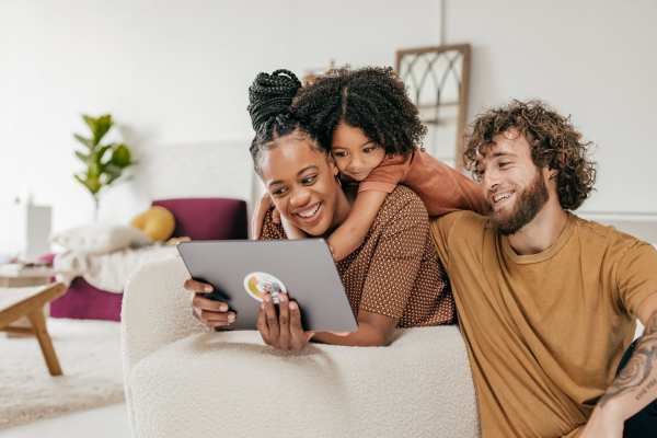 A happy resident family in their apartment at Orchard Trace Gastonia in Gastonia, North Carolina