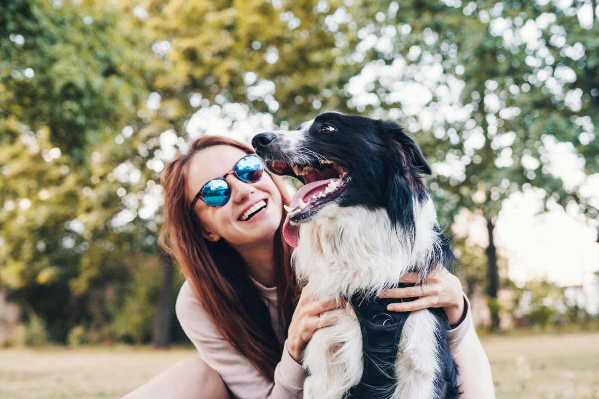 A woman with her pet dog at the pet park at Parkland Village in District Heights, Maryland
