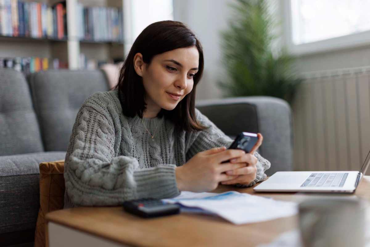 Woman using our resident portal on her mobile at Roanoke Apartments in Louisville, Kentucky