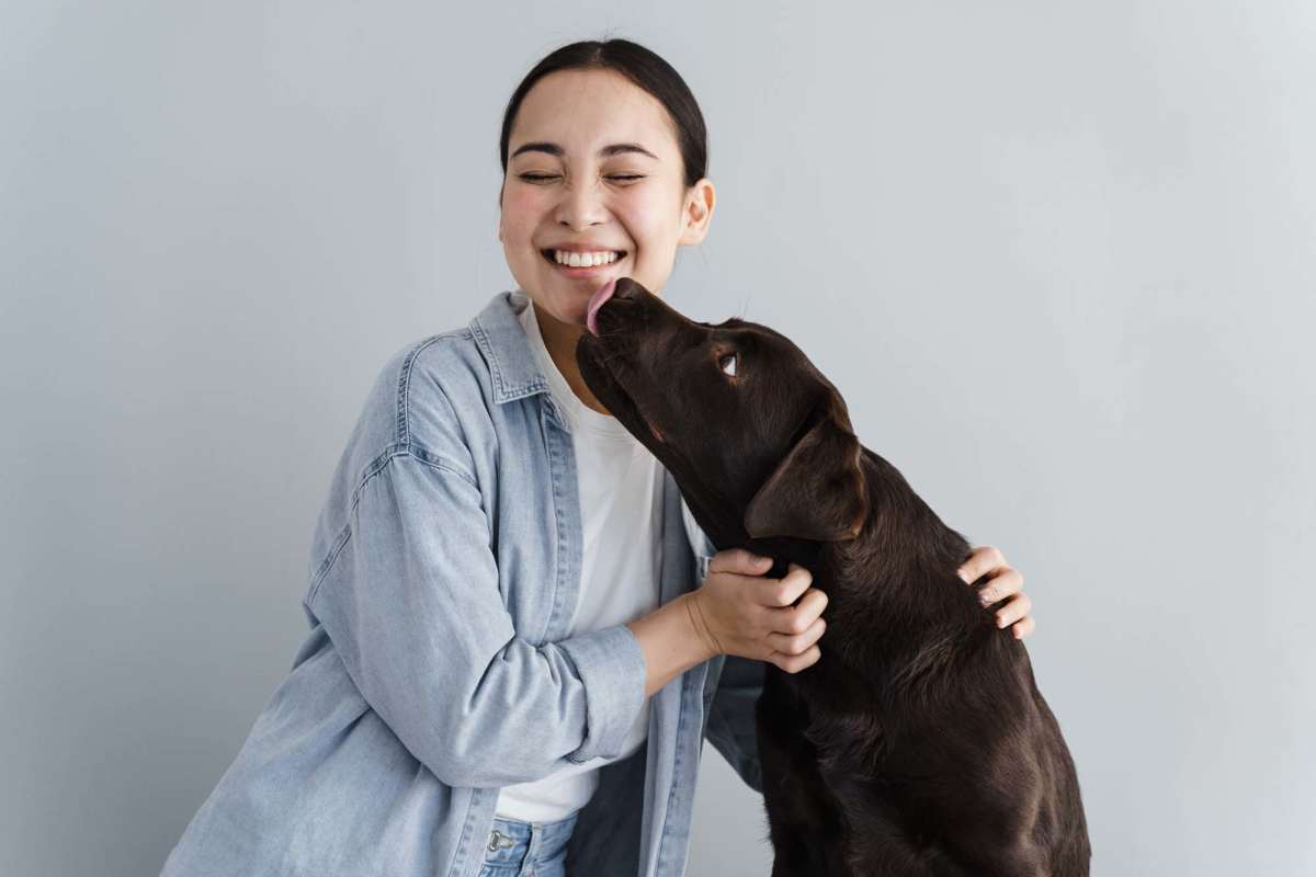 A resident hugging her pet dog at Pilot House in Newport News, Virginia