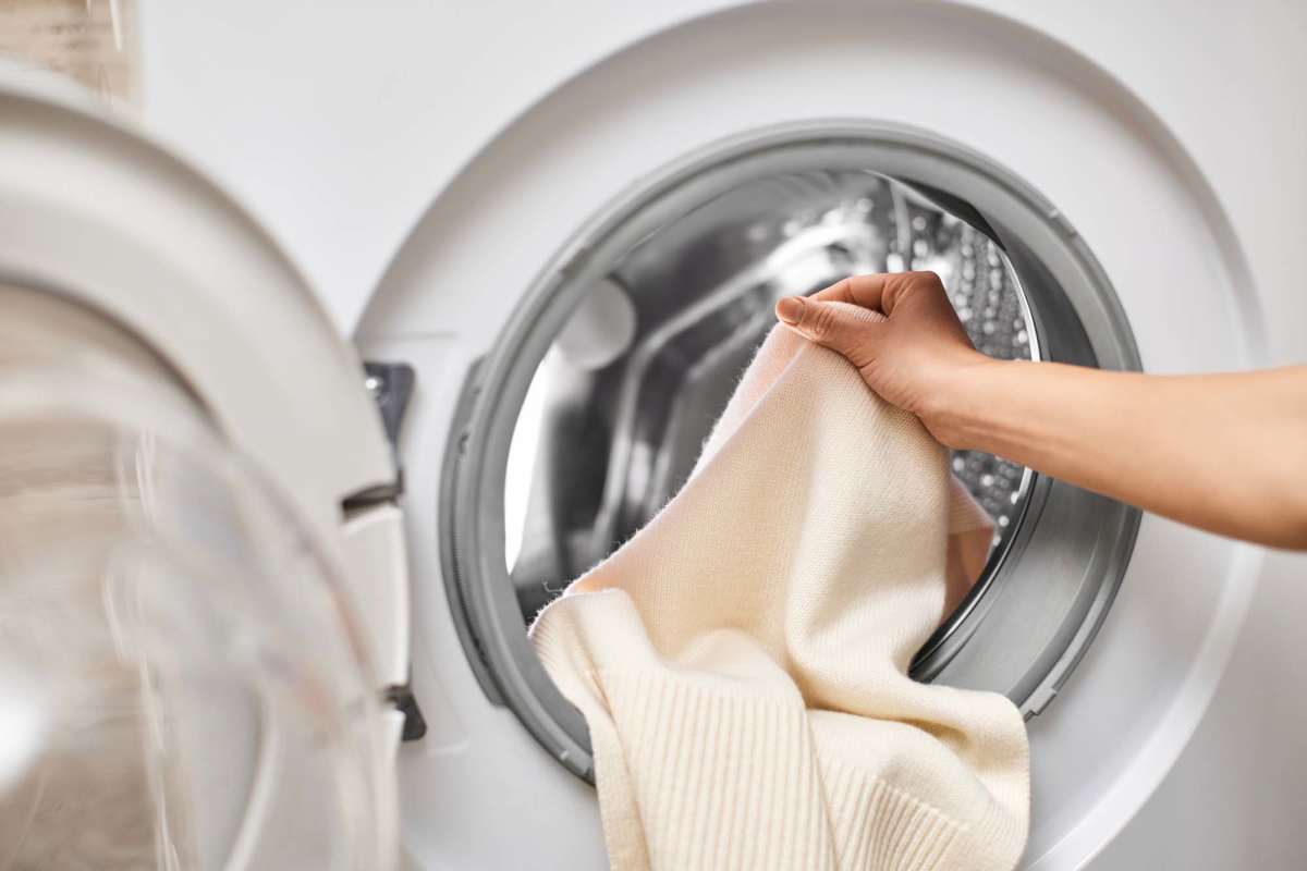 Resident using the washing machine at Fairway Breeze in El Reno, Oklahoma