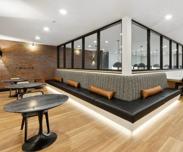 Tables and seating in the community lounge at Lincoln Landing in Hayward, California