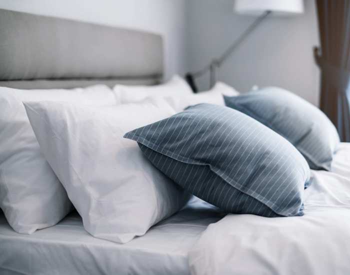 Bed with blue and white pillows, creating a calming atmosphere in a cozy bedroom at Vista Point in Reno, Nevada