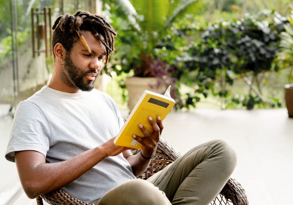 Resident reading in their apartment at Allina La Jolla in San Diego, California