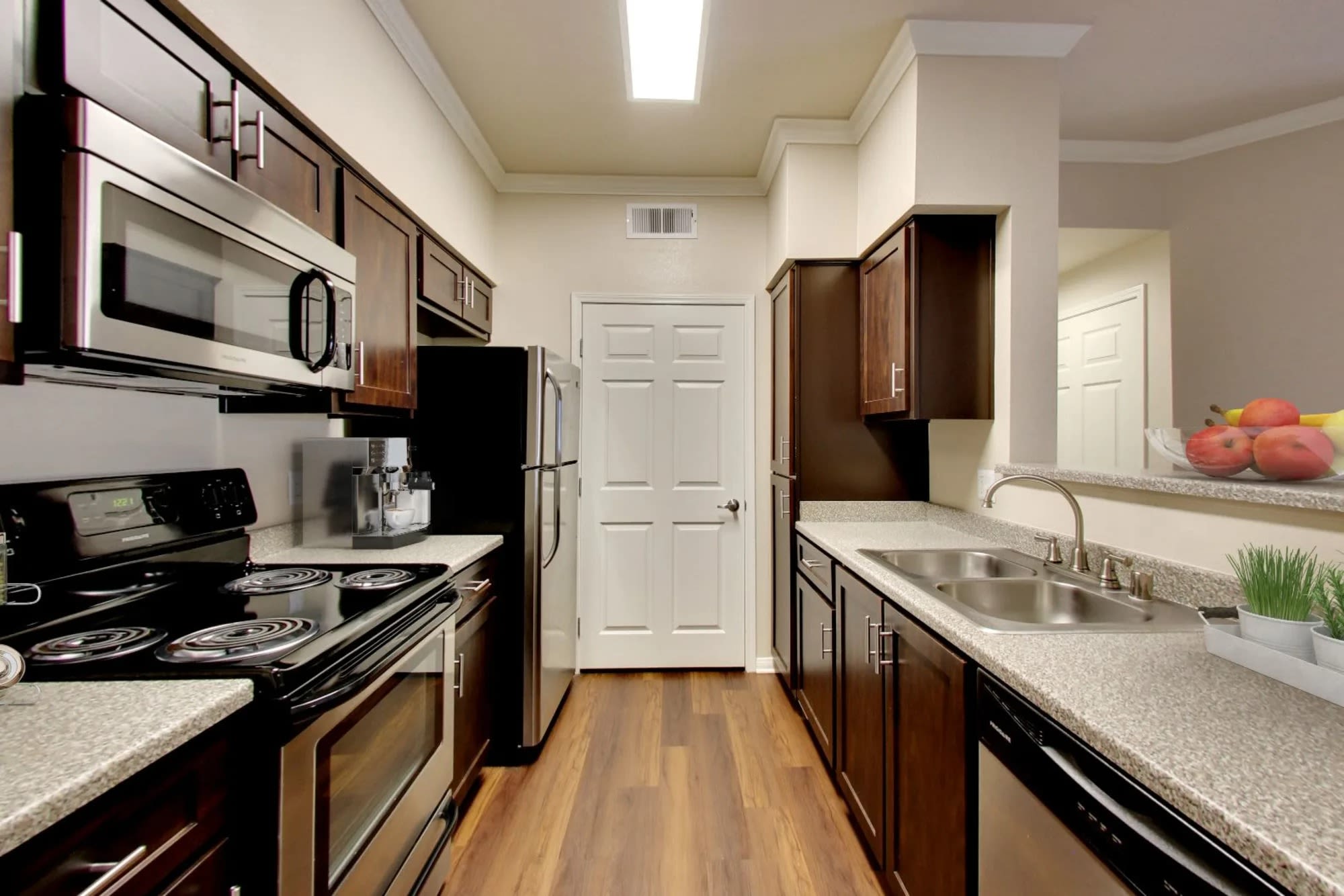 Kitchen with stainless-steel appliances and an island at Hawthorn Village Apartments in Napa, California