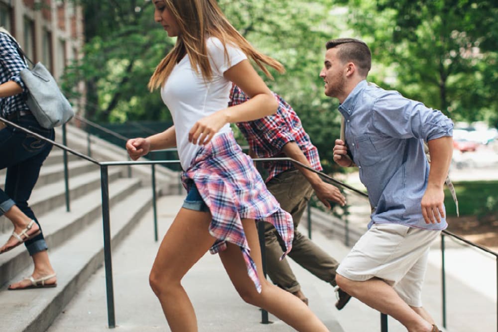 Resident walking up the stairs at HERE State College in State College, Pennsylvania