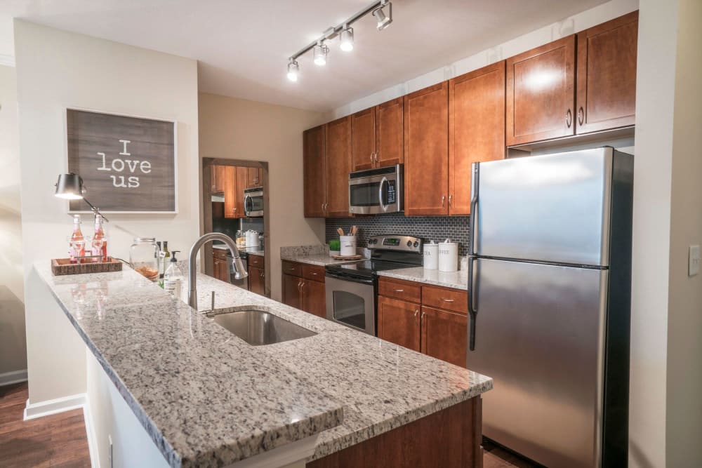 Stainless-steel appliances in the open-concept kitchen of a model apartment at Drift Dunwoody in Dunwoody, Georgia