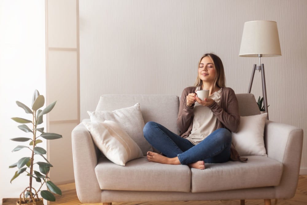 A resident drinking coffee in an apartment at Enclave at Woodcrest Station in Cherry Hill, New Jersey
