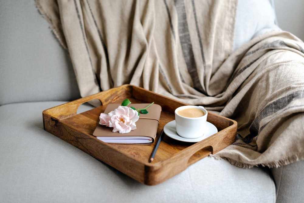 Coffee cup with a dairy on the couch at Reeds Landing Apartments in Edmond, Oklahoma