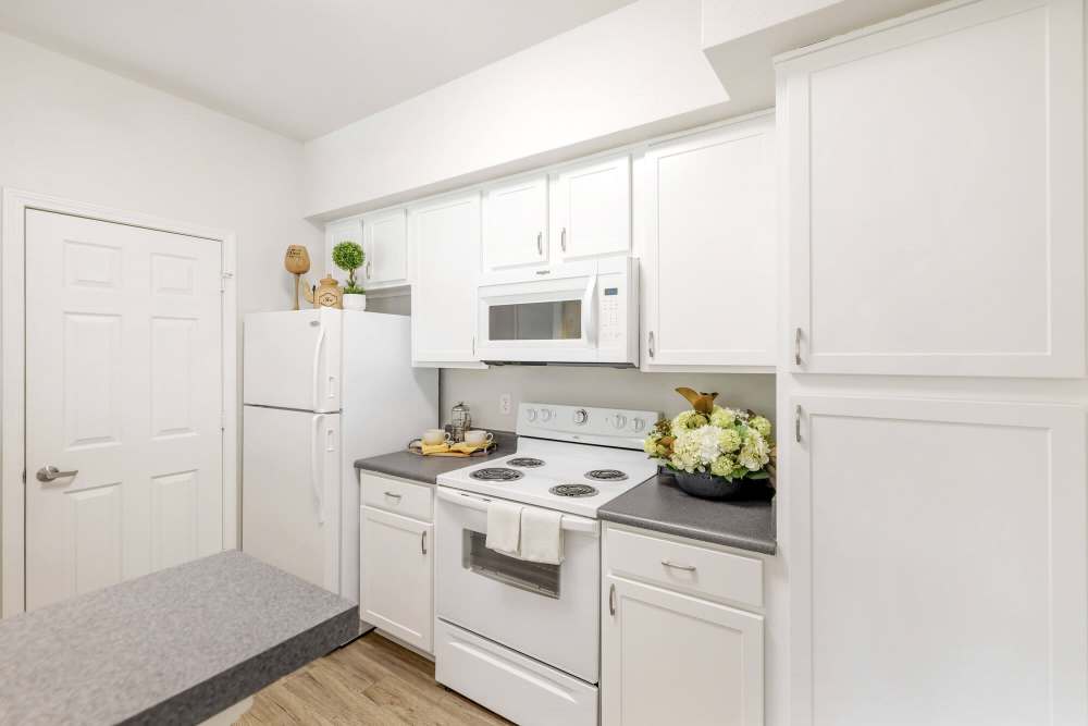 Modern kitchen with wooden cabinets at Eastland Trails in Independence, Missouri