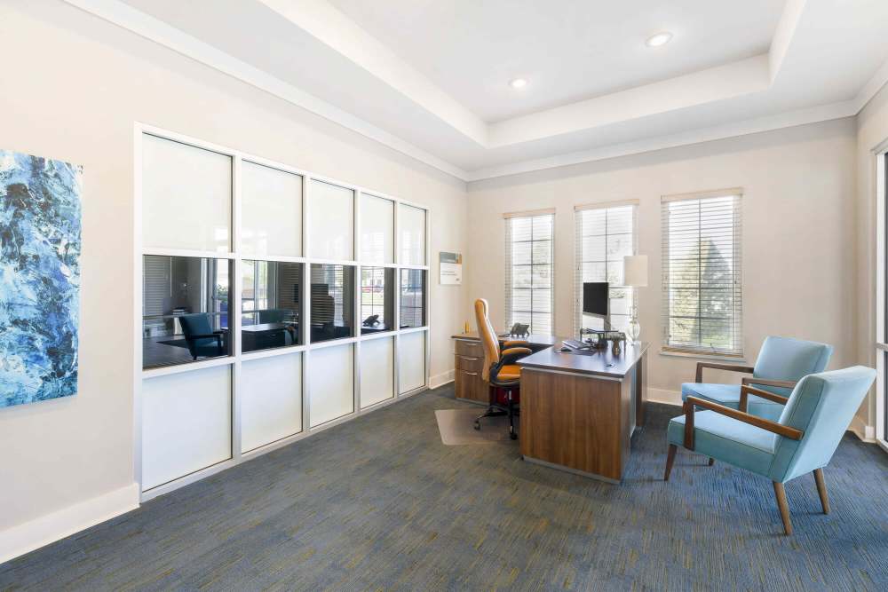 Office room with a desktop and seating at Eastland Trails in Independence, Missouri