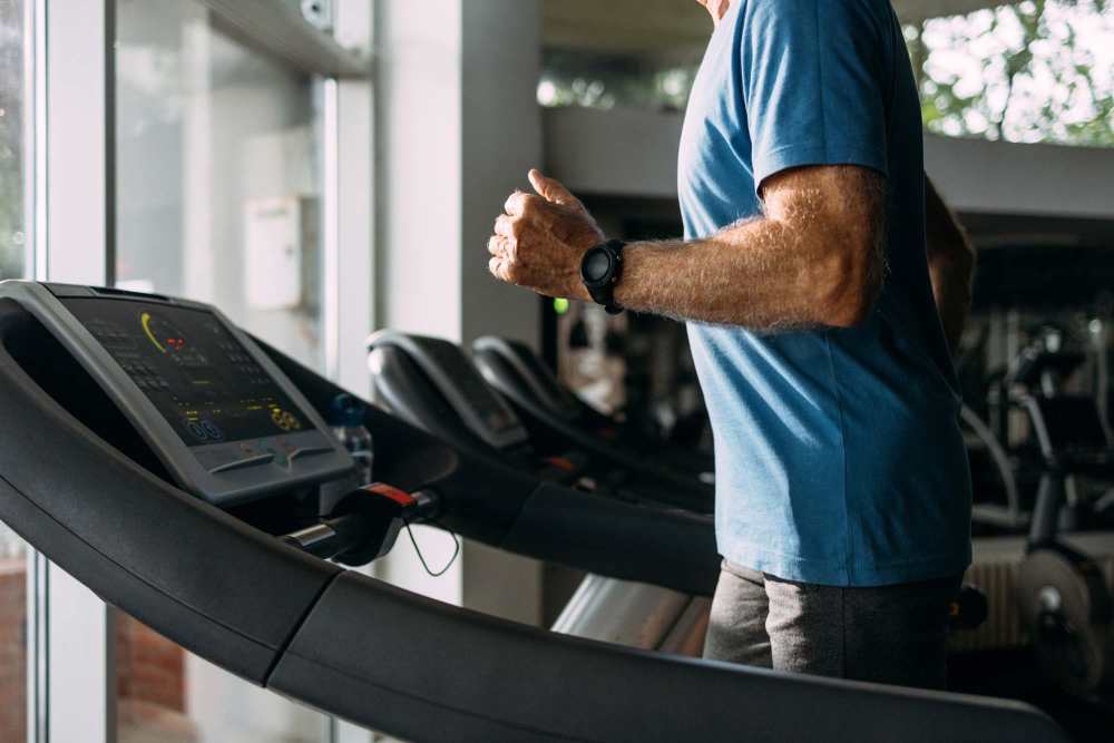 Fitness center with cardio equipment at Ennova Highlands apartments in Arlington, Texas