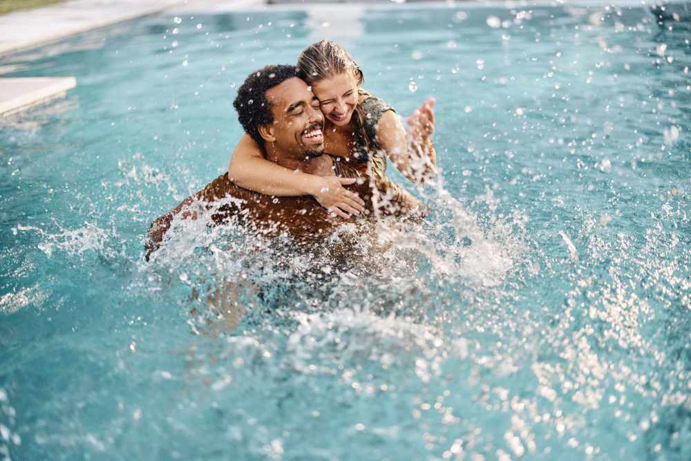 resident couple enjoying in a swimming pool at Hampton Square in Cherry Hill, New Jersey