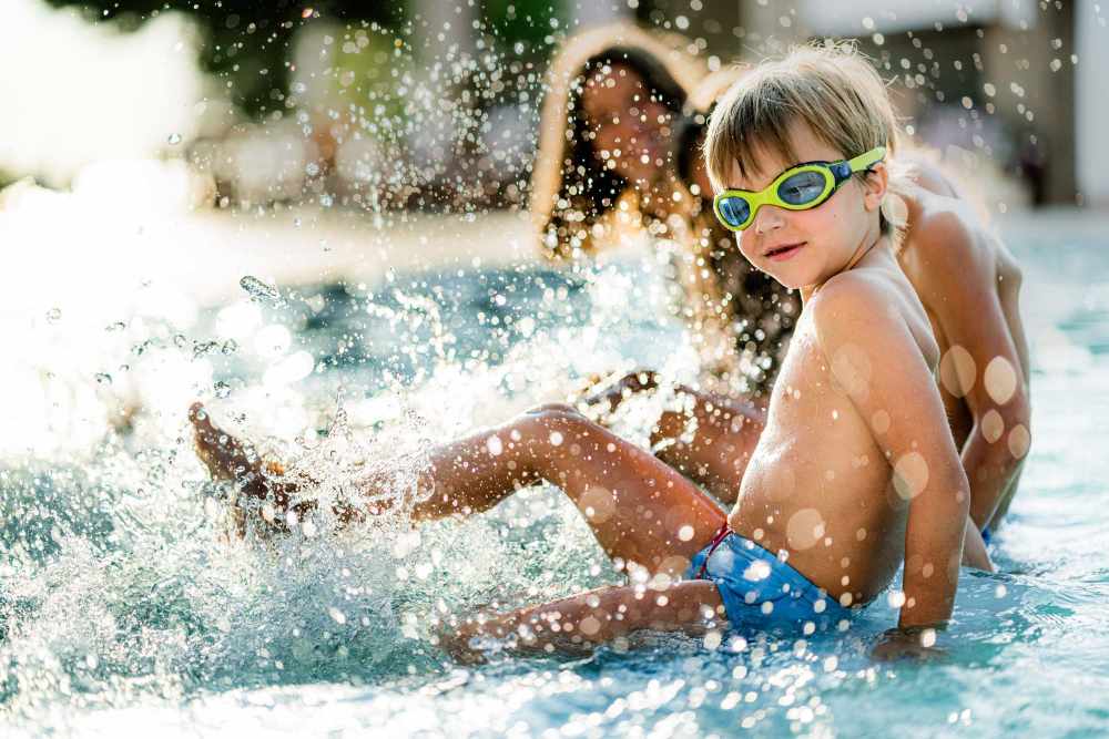 Kids relaxing at the pool's edge at High Point Crossing Apartments in Augusta, Georgia