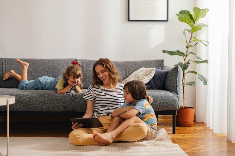 Resident woman with her kids in a living room at Palm Manor Apartments in McAllen, Texas