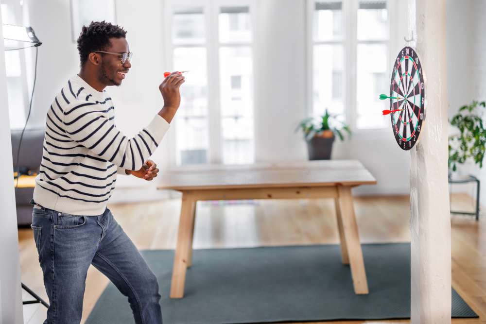 Resident playing darts in the clubhouse at Illinois Place in Indianapolis, Indiana