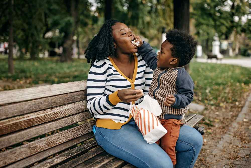 Resident kid playing with her mother in park near Wallace Terrace Apartments in Charlotte, North Carolina