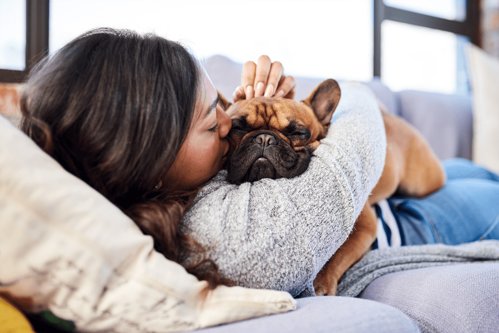 Resident snuggling with her French bulldog at Waterchase Apartment Homes in Wyoming, Michigan