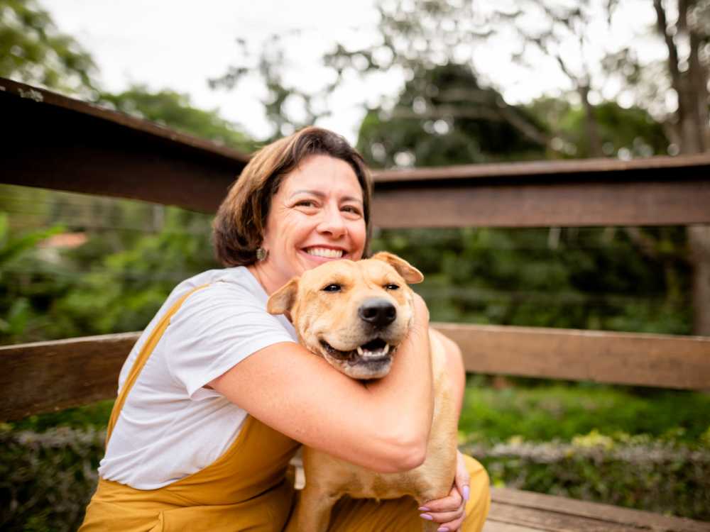 Residents with their pet dog in a park near The Reserve at Brookhaven in Palm Coast, Florida 