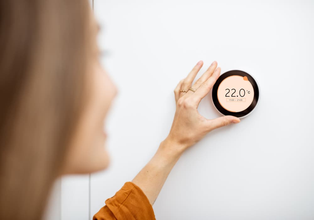Resident adjusting the temperature at CASA Homes in Jacksonville, Florida