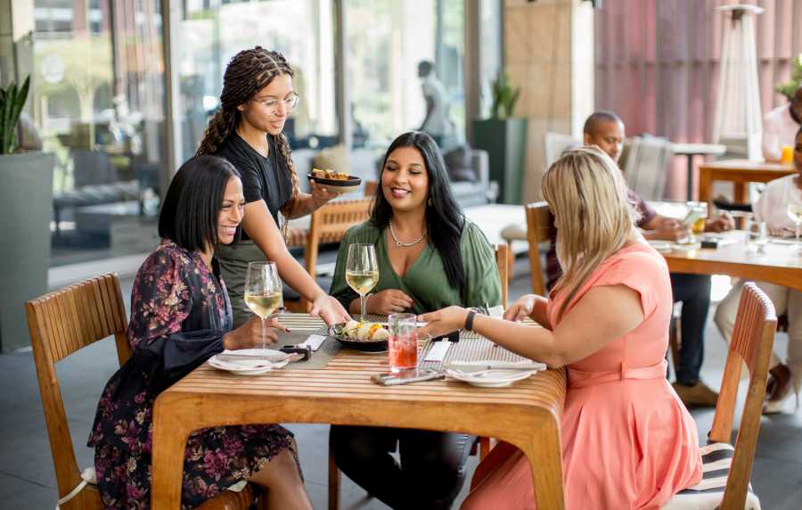 Residents at an outdoor restaurant near Serene at La Villita in Irving, Texas