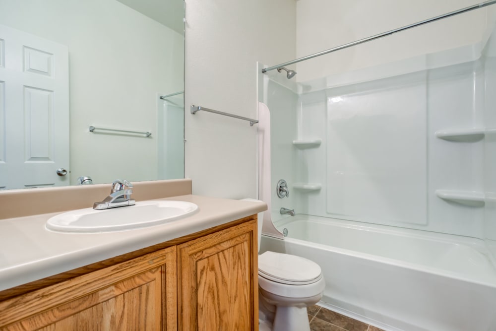 A bathroom with shower and tub at Constellation Park in Lemoore, California