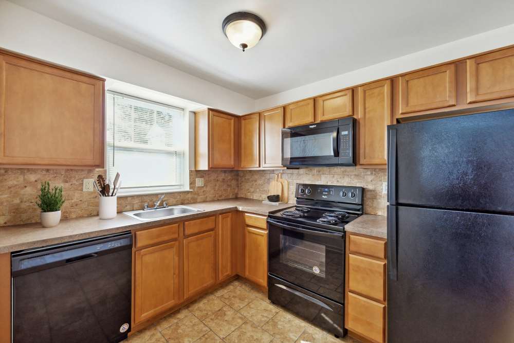 kitchen with wooden cabinets and black appliances