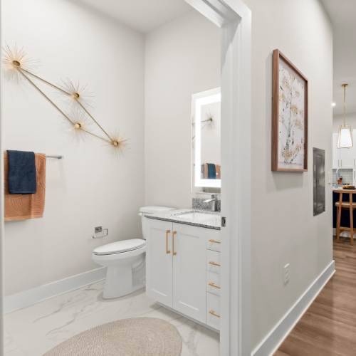 A bathroom interior with a white sink and toilet at EVOQ East Cobb in Marietta, Georgia