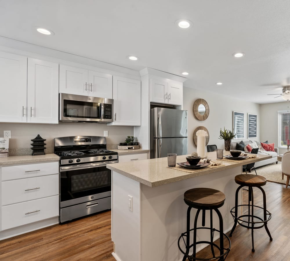 Beautiful updated kitchen with bar setting at Pinebrook Apartment Homes in Fremont, California