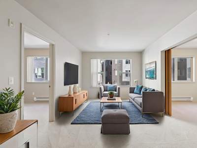 Spacious living room with plush carpeting at at The Blakely in Shoreline, Washington