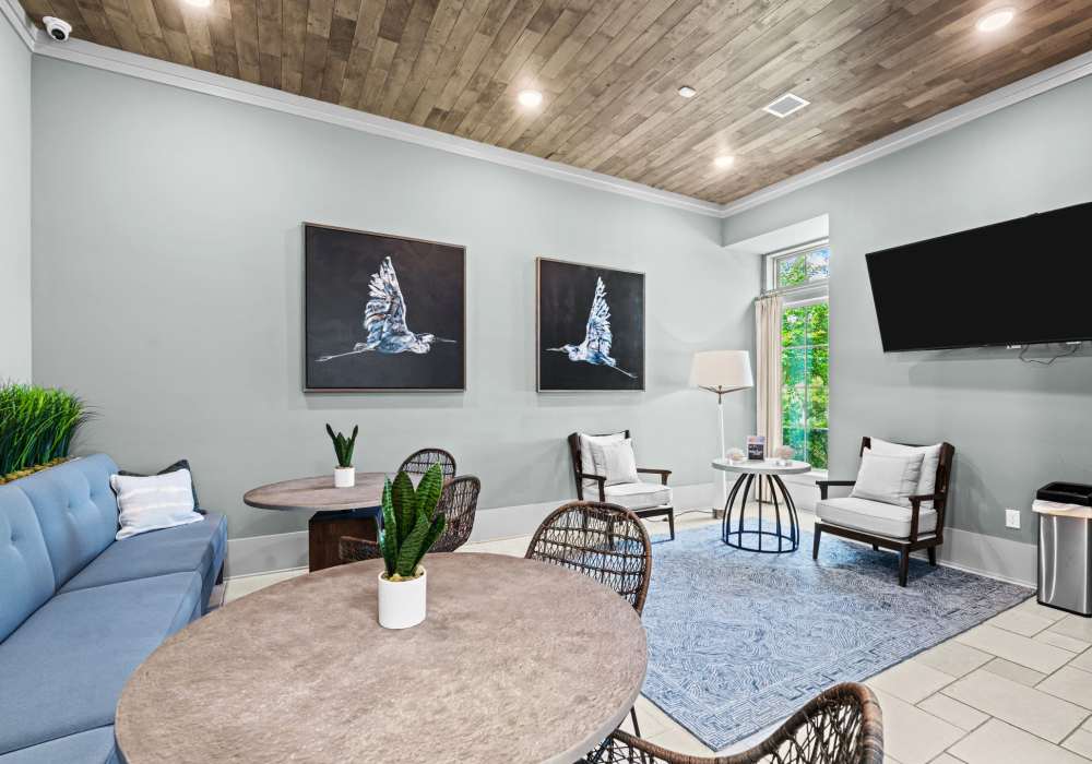 Community clubhouse with large couch, seating and popcorn machine with trolley at Watersound Origins Crossings in Inlet Beach, Florida