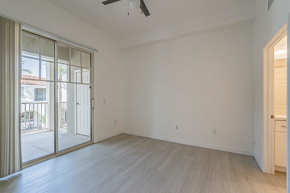 Bedroom with door to balcony at Main Street Lofts at Verrado in Buckeye, Arizona