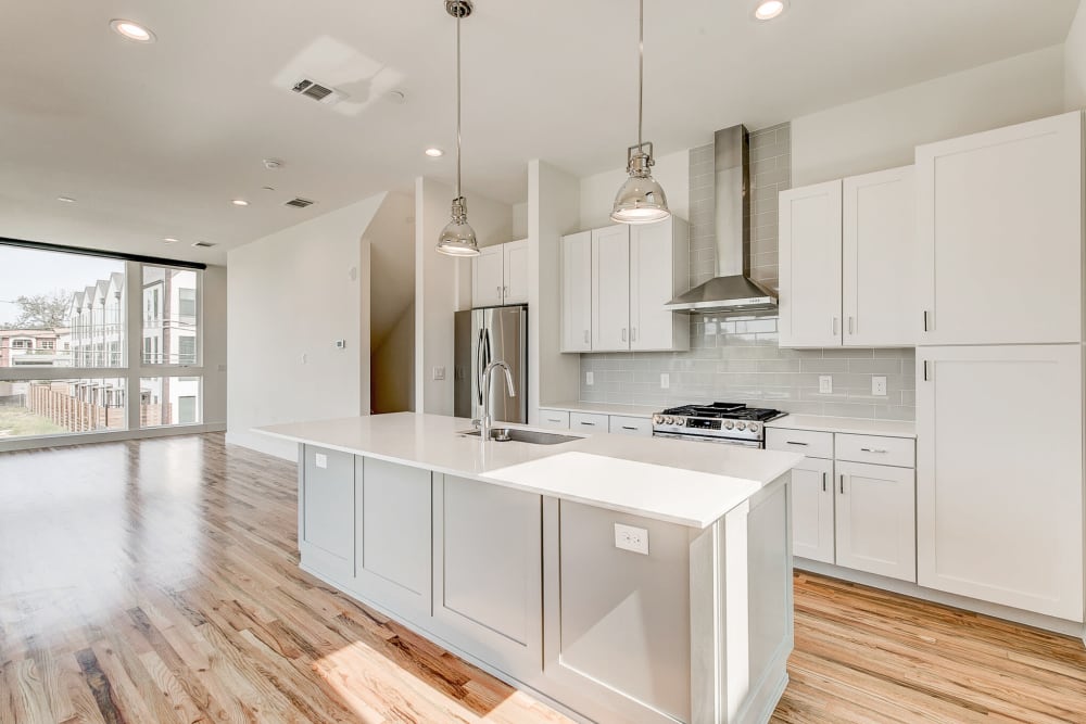 Bright and spacious kitchen with white countertops and cabinets at The Collection Townhomes in Dallas, Texas