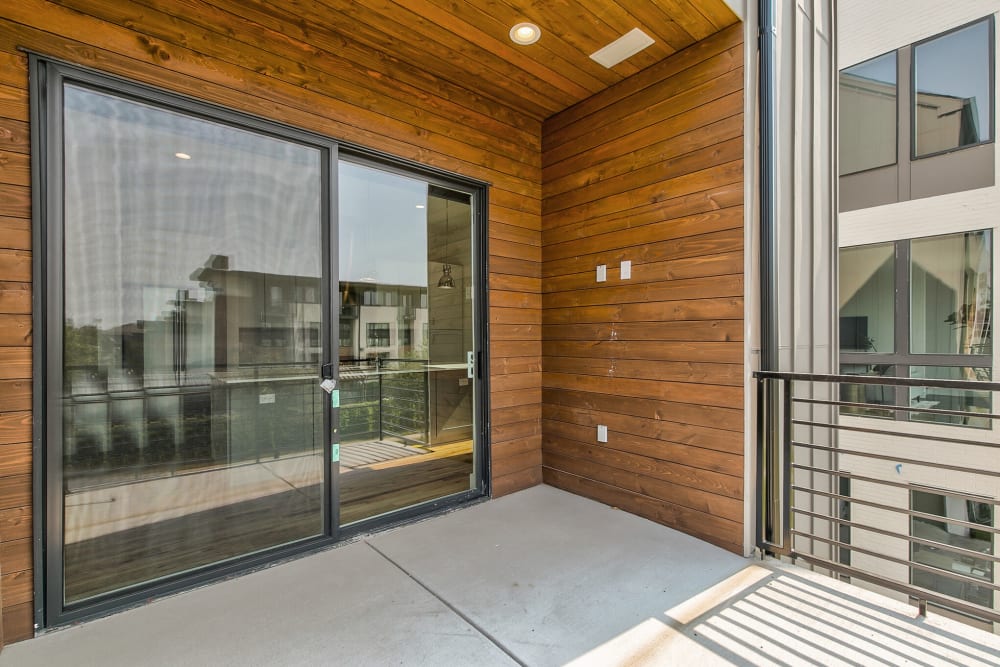 Private balcony with sliding glass doors at The Collection Townhomes in Dallas, Texas