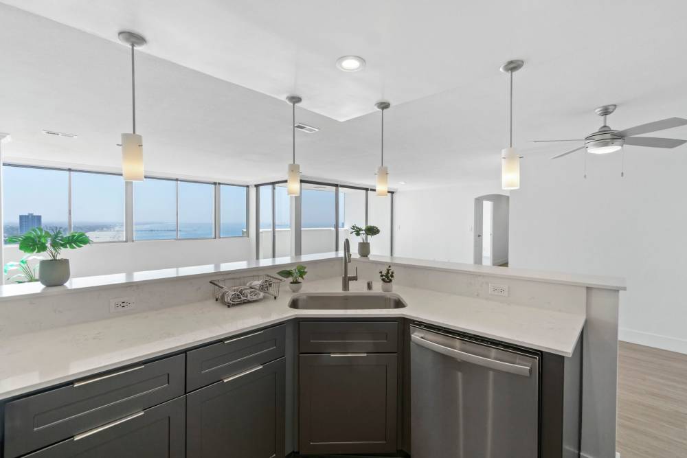 Kitchen with stainless-steel appliances and built-in microwave at 1900 Ocean Apartment Homes in Long Beach,California