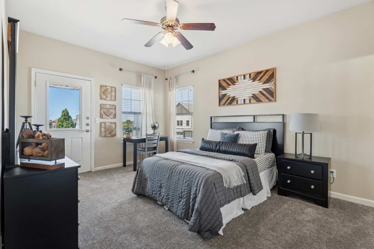 Styled bedroom at Cottage Row Stillwater in Stillwater, Oklahoma