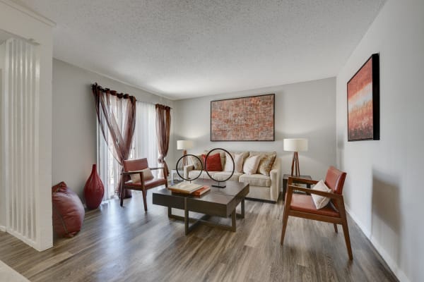 Furnished living room with wood-style flooring in an apartment at The Fredd Townhomes in San Antonio, Texas