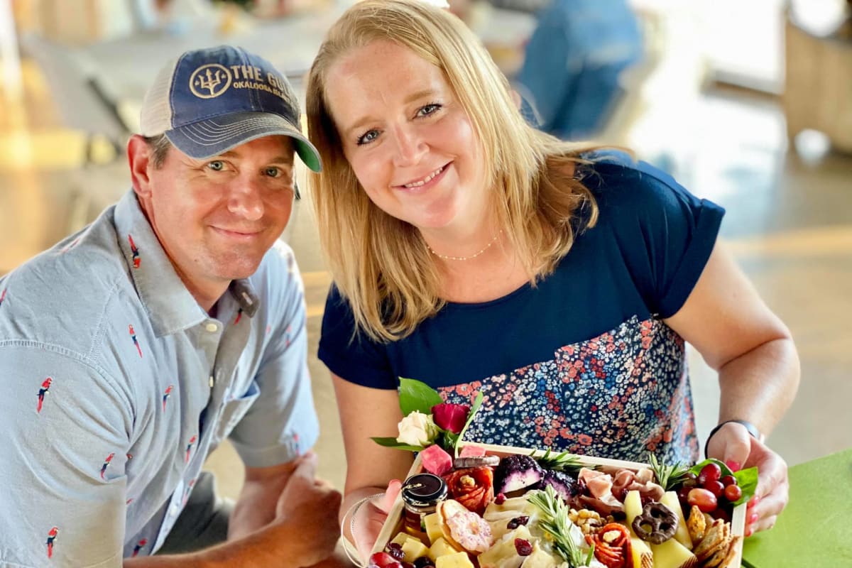 Couple embracing each other on the private patio outside their home at BB Living Harvest in Argyle, Texas